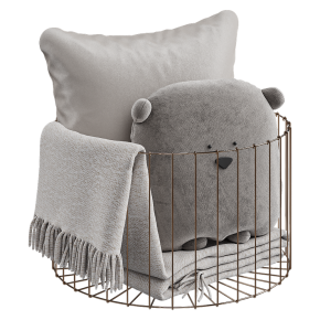 Pillows with a blanket in the basket.